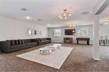 A living room with a large couch and a coffee table.